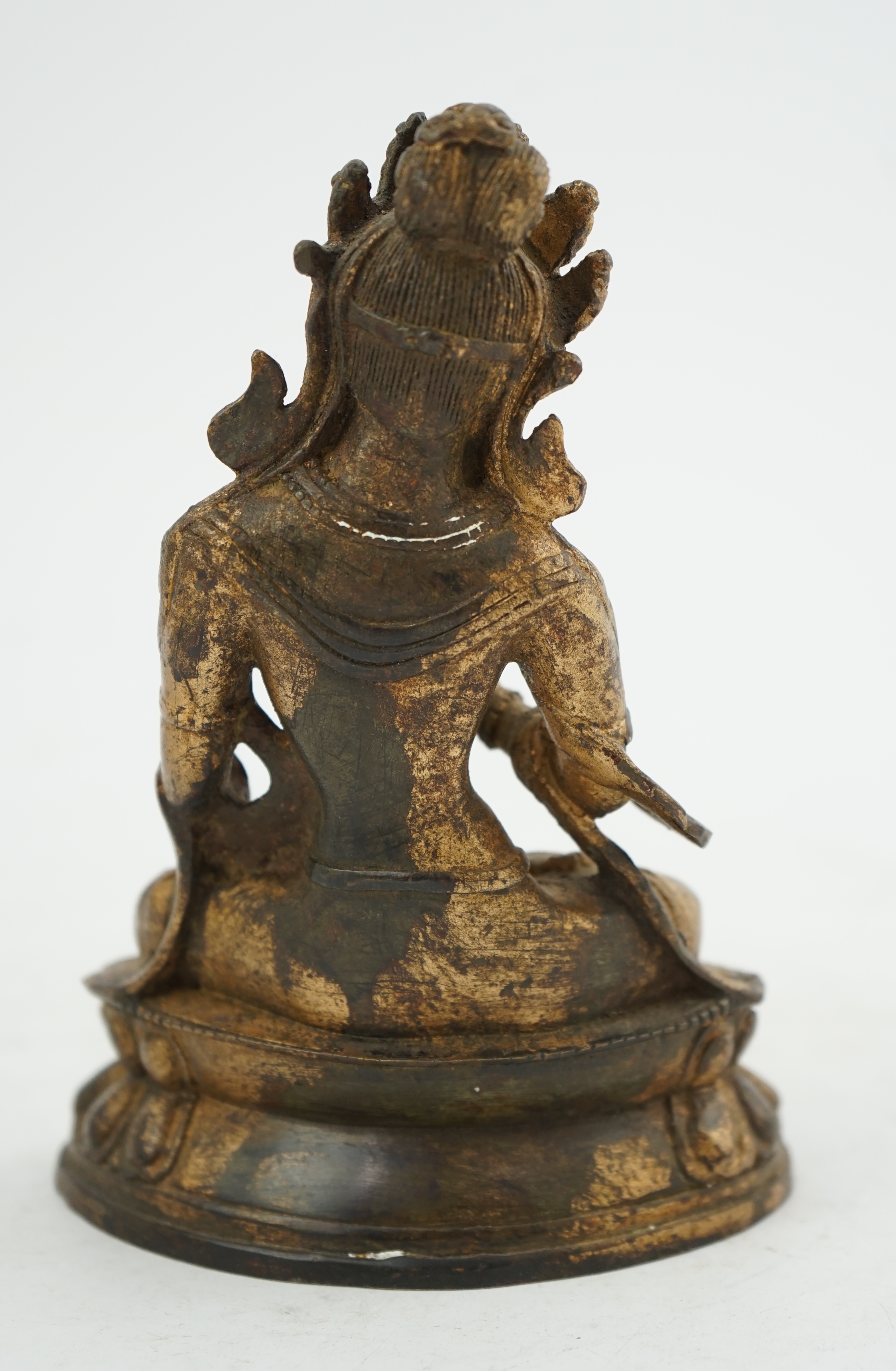 A Tibetan gilt bronze figure of seated Tara, on a double lotus throne, 16.5cm high. Condition - good